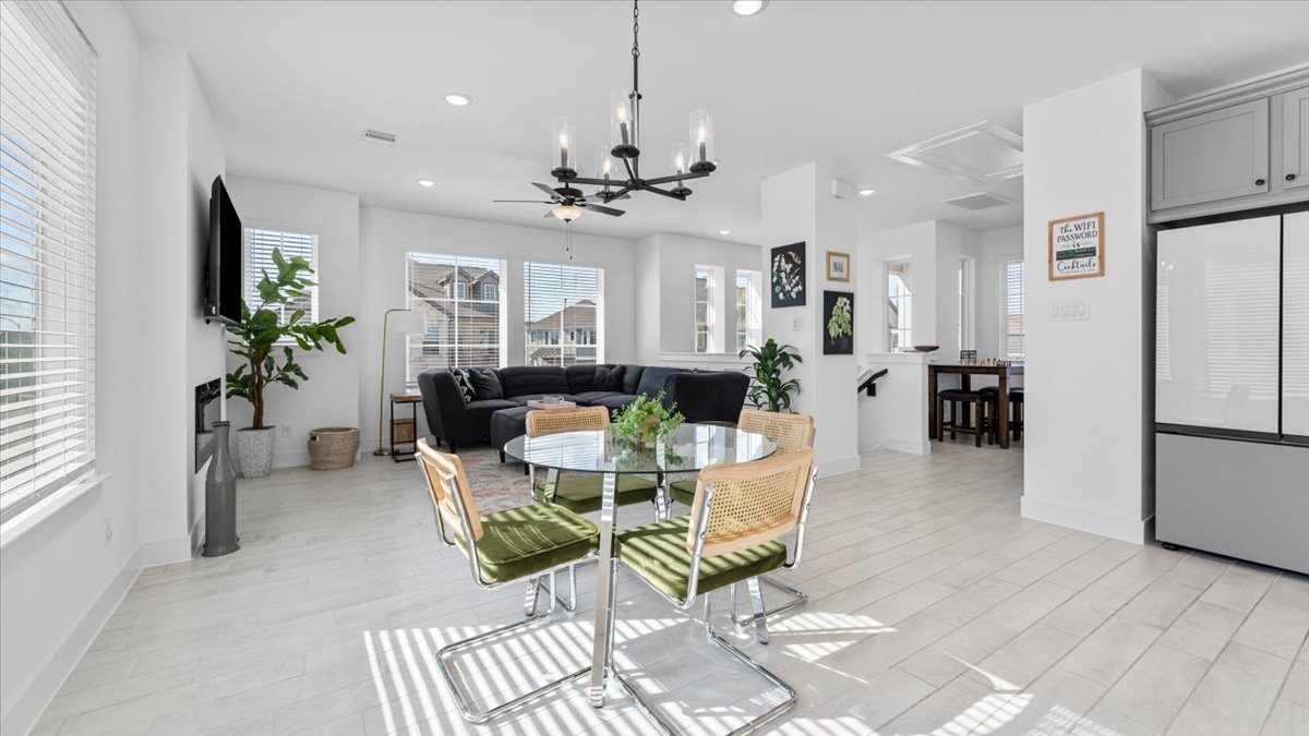 Modern open-concept dining and living area in midterm rentals in Cypress TX, featuring natural light and stylish furnishings.