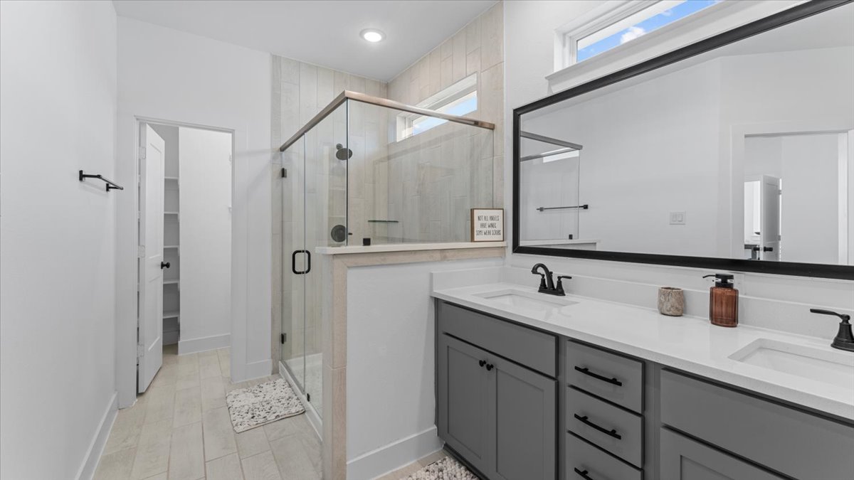 Modern bathroom with dual sinks and glass shower – Stylish bathroom in midterm rentals Cypress TX for traveling professionals, featuring double vanity and walk-in shower.